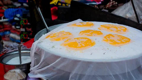 IndiaPictures/Getty Images The snack is dolloped with saffron foam and then covered in a fine muslin and set atop slabs of ice (Credit: IndiaPictures/Getty Images)