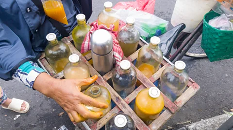 Ahmad Darmansyah/Getty Images The jamu gendong make and sell their tinctures daily, with each jamu designed to have different properties (Credit: Ahmad Darmansyah/Getty Images)