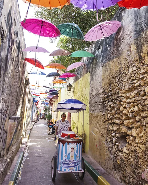 Jeff Greenberg/Getty Images Street vendors sell chicha in Colombia (Credit: Jeff Greenberg/Getty Images)