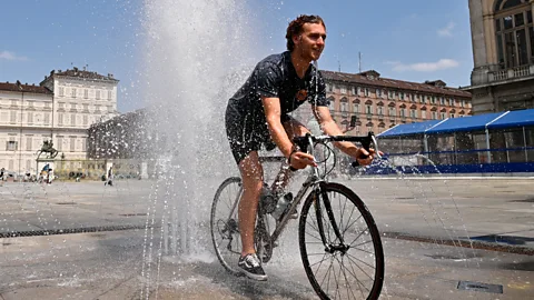 Getty Images A man rides a bicycle inside a fountain in Piazza Castello on July 11 2023 Turin Italy (Credit: Getty Images)