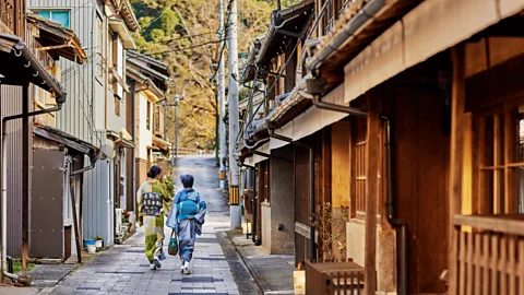 Ozu City Tourism Two people in traditional dress walking through Ozu historic centre