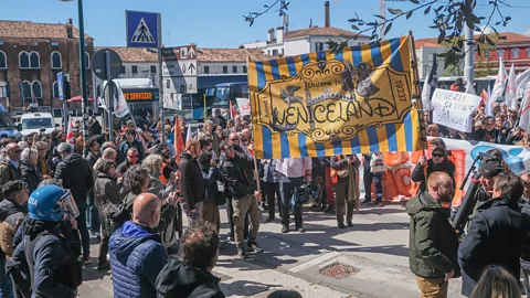 Getty Images Venice residents have taken to the streets to protest against the new €5 entry ticket (Credit: Getty Images)