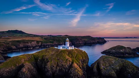 Hawlfraint y Goron/Crown Copyright Strumble Head Lighthouse is perched on a tiny island just off the Pembrokeshire coast (Credit: Hawlfraint y Goron/Crown Copyright)