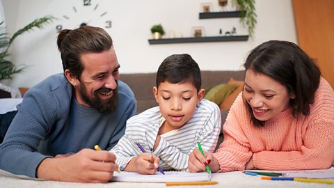 Parents and child drawing on paper 