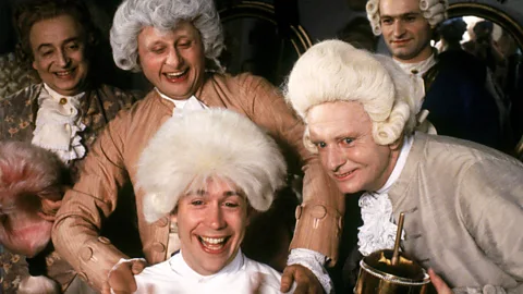 Alamy Tom Hulce and cast in a scene of Amadeus (Credit: Alamy)