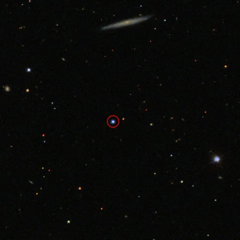 Sloan Digital Sky Survey The ultramassive black hole known as TON 618 sits amidst a distant quasar (circled) and is one of the largest yet to be discovered (Credit: Sloan Digital Sky Survey)