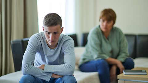 A mother talking to her son, who is upset