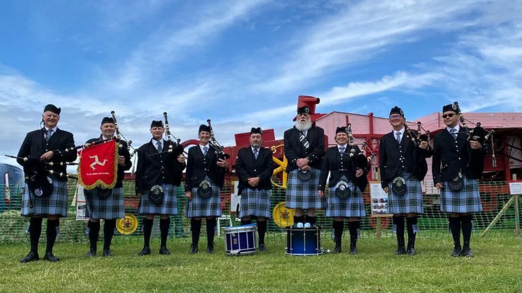 Members of Ellan Vannin Pipes and Drums in Manx tartan