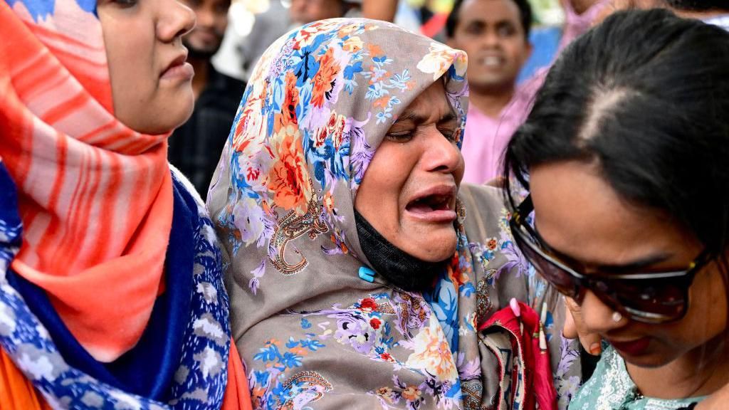 A forcibly disappeared person's mother cries, during a human chain to mark the International Day of the Victims of Enforced Disappearances, in Dhaka