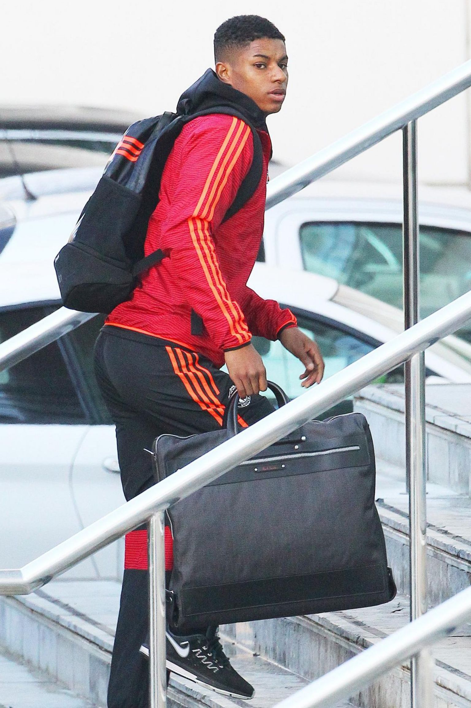 A teenage Marcus Rashford climbs some steps