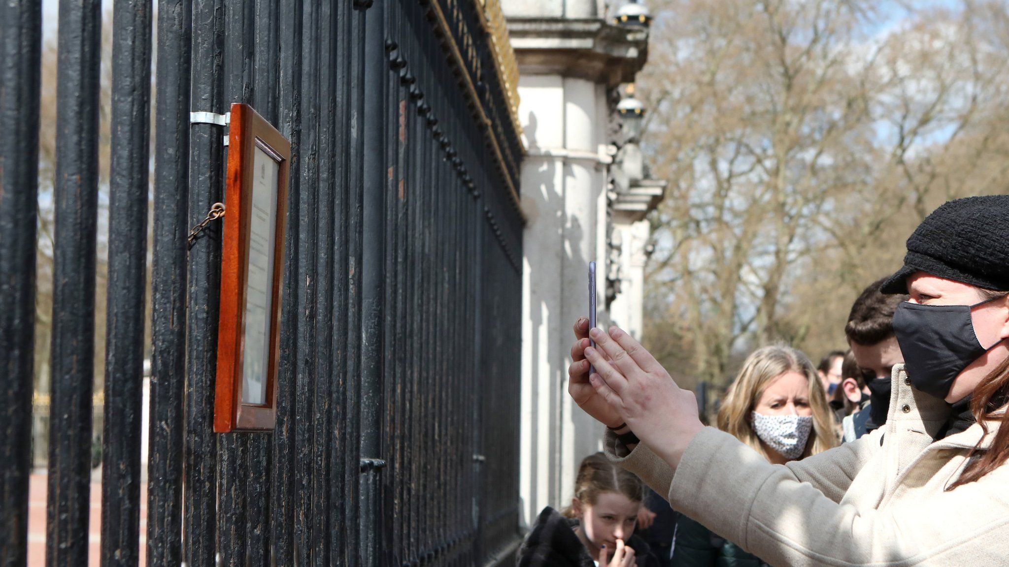 A member of the public takes a photograph of the Palace notice on a phone on 9 April 2021