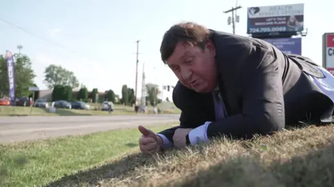 BBC reporter Gary O'Donoghue takes cover 