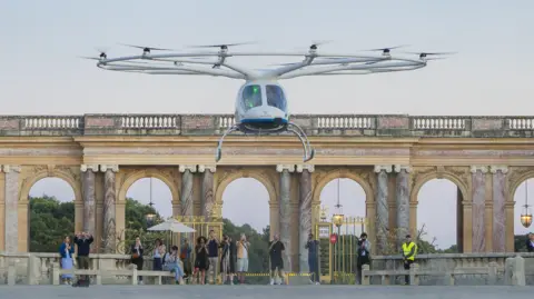 Resembling a large drone, the two-seater VoloCity aircraft takes off at the Palace of Versaille