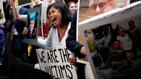 Getty Images Clariss Moore holds photograph of her daughter Danielle Moore who was killed in the Ethiopian Airlines Flight 302