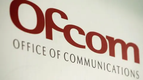 Ofcom logo on a sign. It reads in a red font: Ofcom, office of communications.