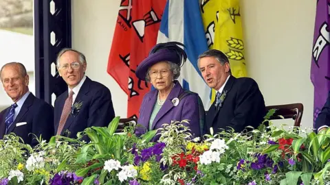 Getty Images Queen Elizabeth sits with Presiding officer Sir David Steel (right), First Minister Donald Dewar (second left) and Prince Philip (far left), at the close of the ceremony for the new Scottish Parliament in Edinburgh in 1999