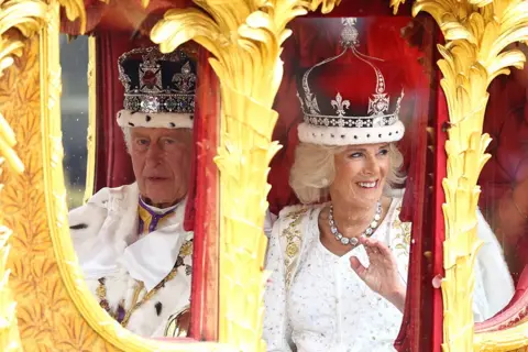 Reuters King Charles and Queen Camilla travel from Westminster Abbey in the Gold State Coach