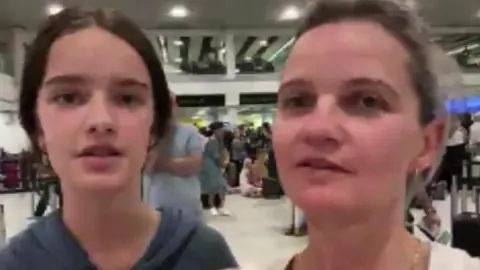 Ewelina Sornat Ewelina Sornat with her daughter at a packed Gatwick terminal