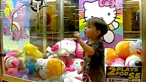 Child surrounded by toys