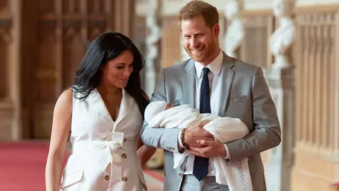 PA The Duke and Duchess of Sussex and their son