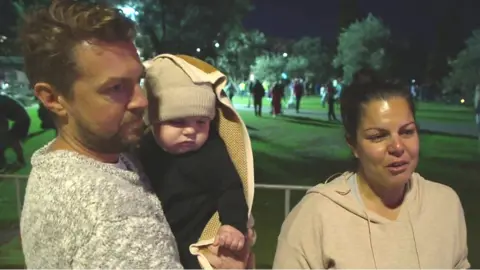 A family in Sydney attending a vigil for the Sydney stabbing victims.