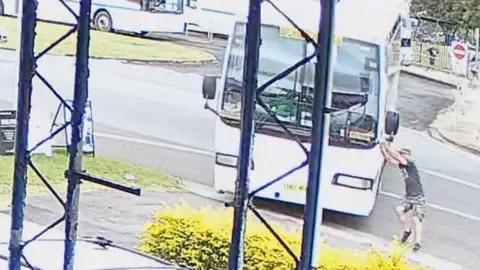 On-duty teacher running alongside runaway bus