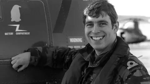 Press Association Prince Andrew at Port Stanley stands next to a helicopter for HMS Invincible