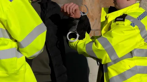 Officers arresting suspected shoplifter