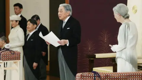 Reuters Japan's Emperor Akihito, flanked by Empress Michiko, delivers his final address as emperor