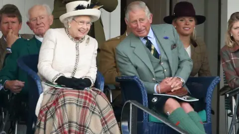 Getty Images Queen Elizabeth II and Prince Charles, Prince of Wales watch the action during the Braemar Highland Games