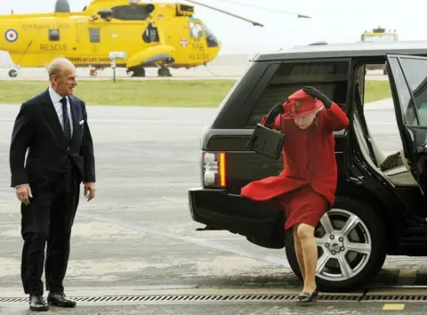 PA Media Britain's Queen Elizabeth II and the Duke of Edinburgh arrive at a windy RAF Valley in Anglesey, to visit their grandson Prince William at the base.