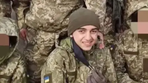 Brahim smiling in the middle of other soldiers in Ukrainian uniform