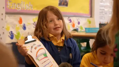 A school pupil with her bucket of kindness