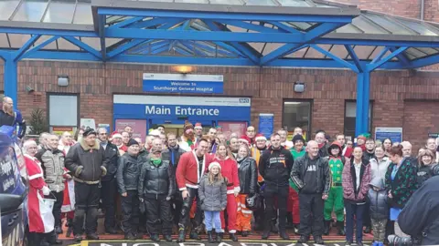 North East Lincolnshire Council A group of motorcyclists, children and hospital staff stood in front of Scunthorpe General Hospital main entrance.