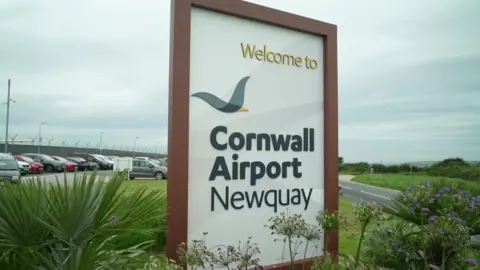 Cornwall Airport Newquay A signing saying "Welcome to Cornwall Airport Newquay" at the airport site's entrance