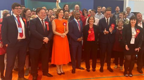 Wales' First Minister Vaughan Gething with winning Labour candidates and supporters at the count in Cardiff 