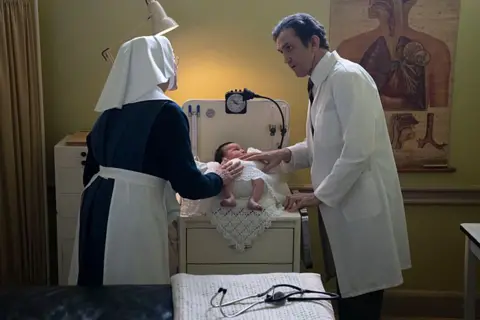 BBC/Neal Street Productions Sister Julienne (Jenny Agutter) and Dr Turner (Stephen McGann) with a baby on the set of the show