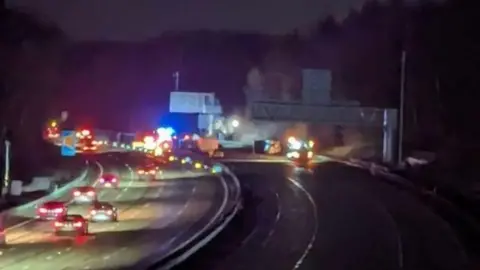 Night time images of the road at the time of the crash, cars can be seen and smoke is in the distance