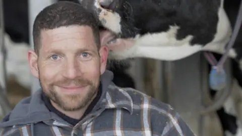 Ben Loewith and a cow