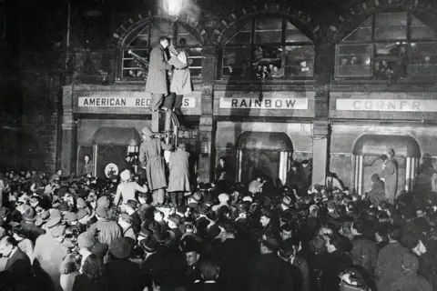 Getty Images The American Red Cross' Rainbow Corner, which has been opened day and night for London, visiting GI's since November 11, 1942, has closing its doors on 6 January 1946 with lots of people outside