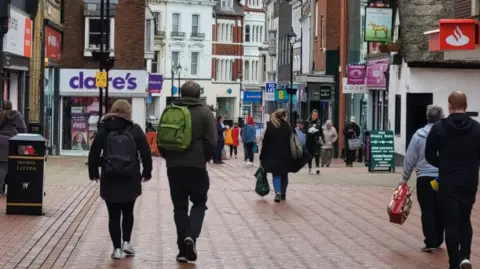 BBC People walking through Wrexham city centre