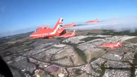 Red Arrows fly over Glastonbury site