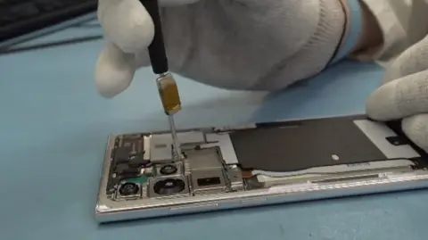 A mobile phone being repaired.