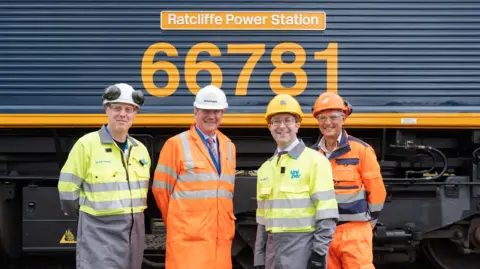 Supplied Four men in front of train