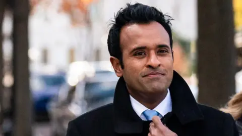 Close up of Vivek Ramaswamy outside wearing a suit and tie