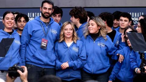 Italy's Prime Minister Giorgia Meloni surrounded by young political activists