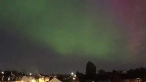 Northern Lights shining green and pink in the nightsky