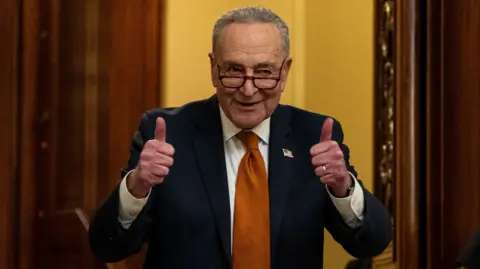 Chuck Schumer smiles and gives a double thumbs up