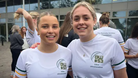 Friends, Abi Brant and Freya Tyler standing next to each other wearing matching white t-shirts which say BW#53 53K ultramarathon. 