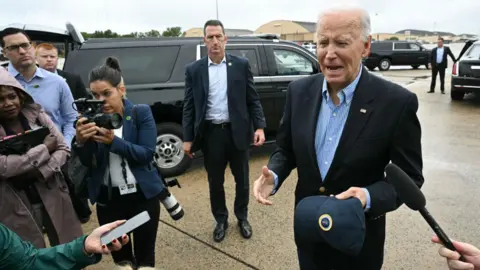 Biden speaking to reporters on the tarmac